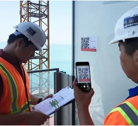 Worker scanning QR code during safety inspection